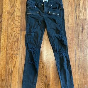 Distressed black skinny jeans